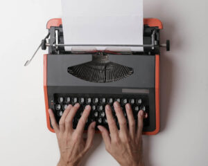 Surgical coordinator writing on a typewriter 